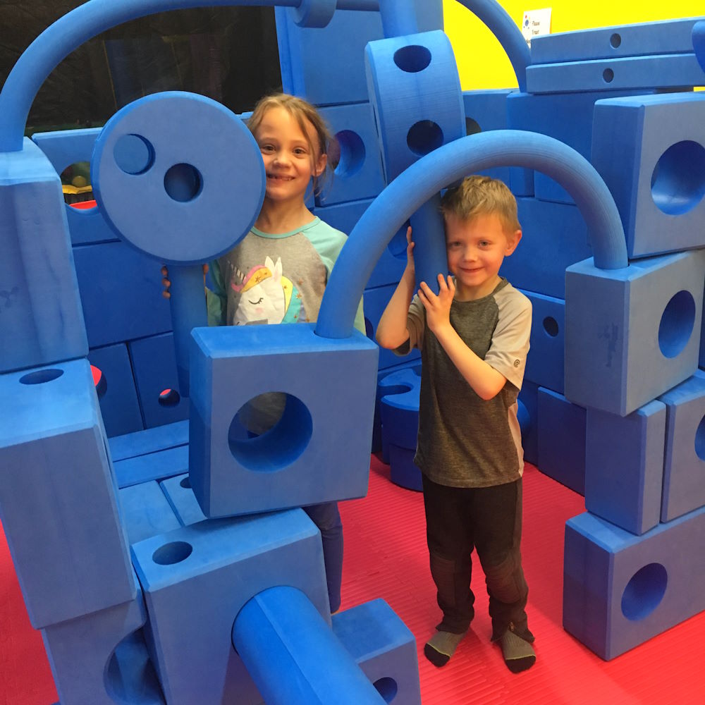 Kids Wonder kids playing with big blue blocks